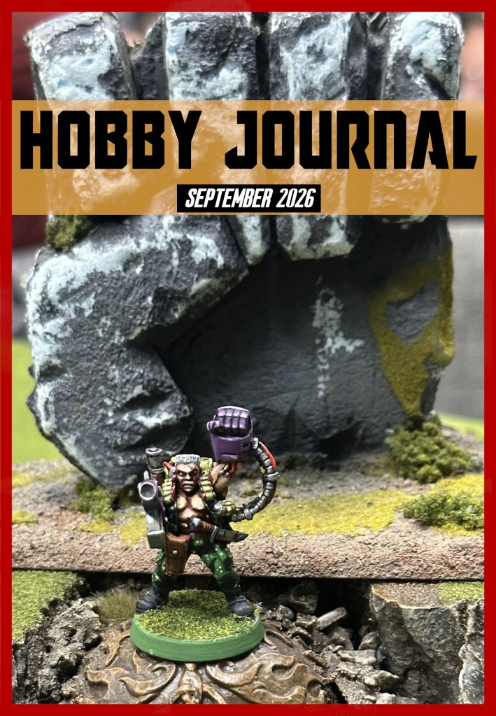 A detailed miniature figure posed in front of a large sculpted hand, accompanied by a title banner for 'Hobby Journal' dated September 2026.